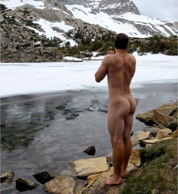 Naked guys under a waterfall