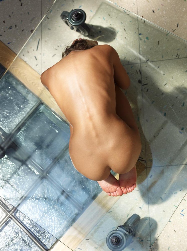 Naked woman on a glass table