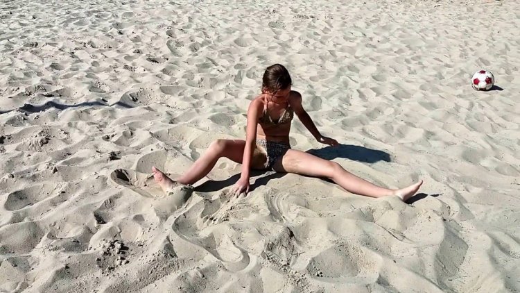 Little gymnast on the beach