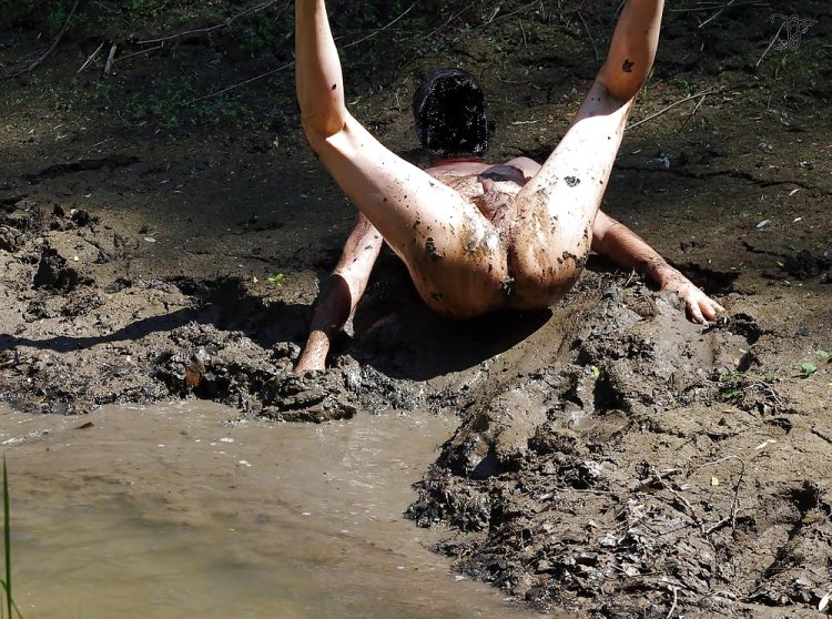 Naked women are lying in mud