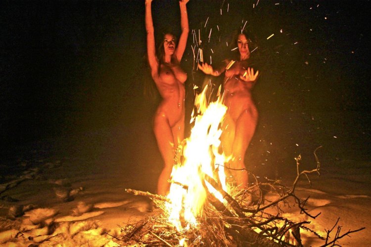 Beautiful naked women by the fireplace