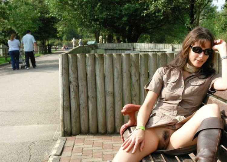 A woman on a bench without panties
