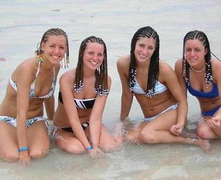 Students in swimsuits on the beach