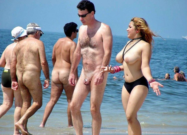 Naked women among men on the beach