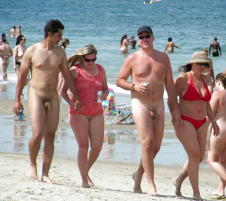 Naked women among men on the beach