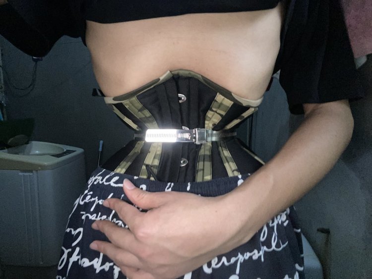 Girls chained in a corset