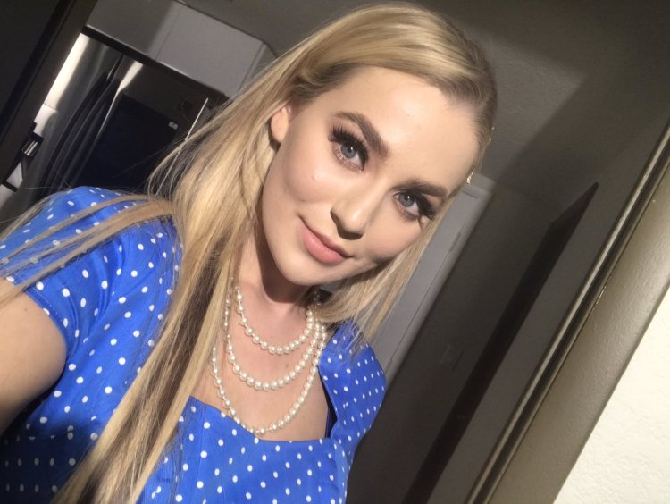 A guy with a tattoo sitting on the floor of a selfie in the mirror