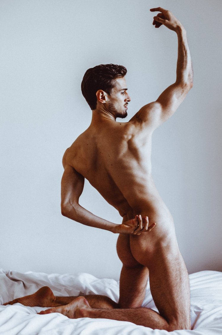 The guy is naked in a strict vest reference