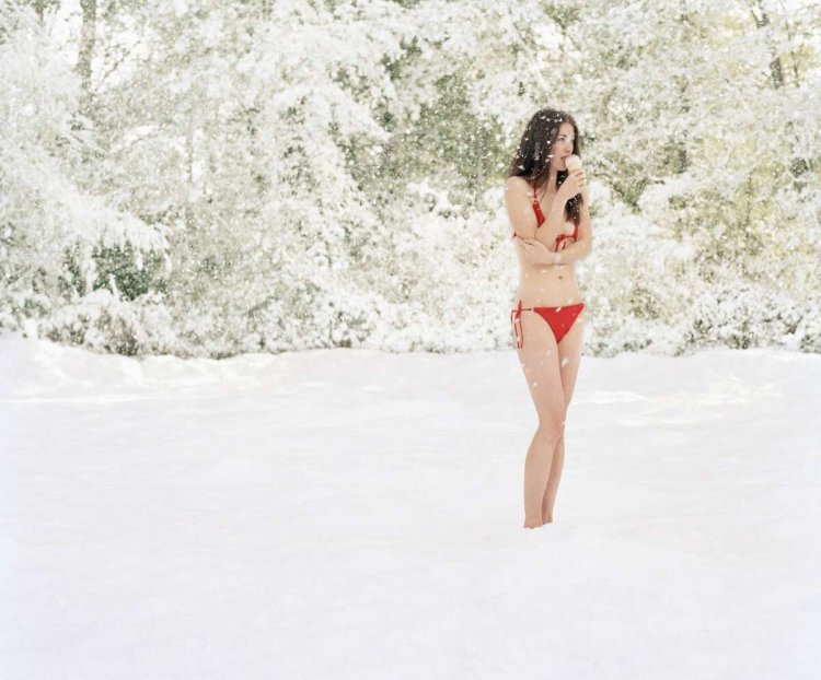 Photo shoot on the lake in the winter in a swimsuit