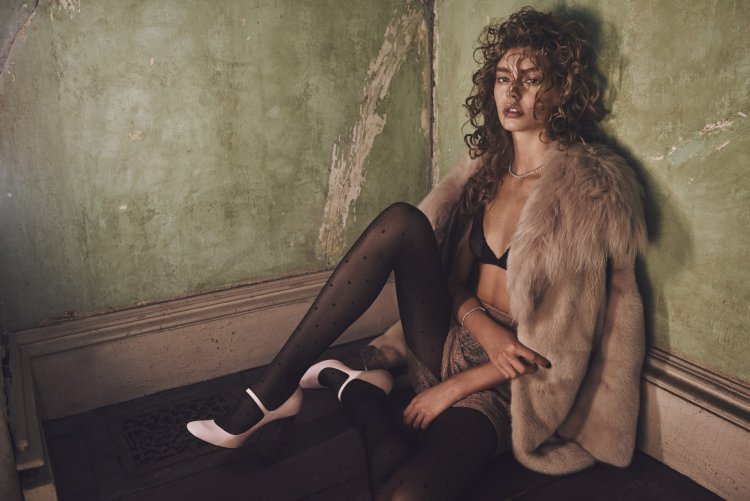 Photo shoot in a fur coat and stockings