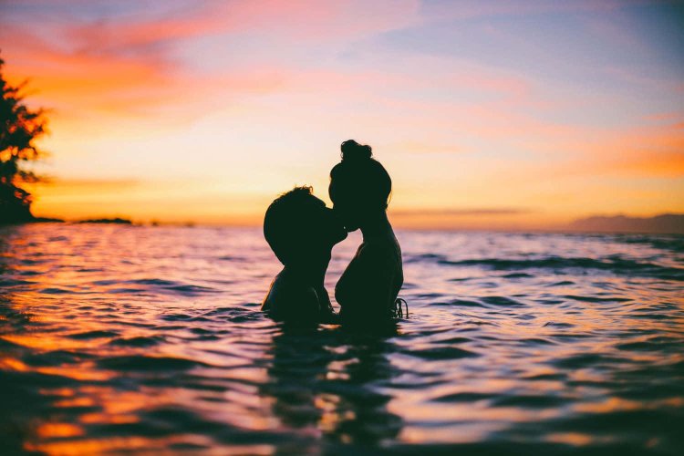 Lovers at sunset on the shore