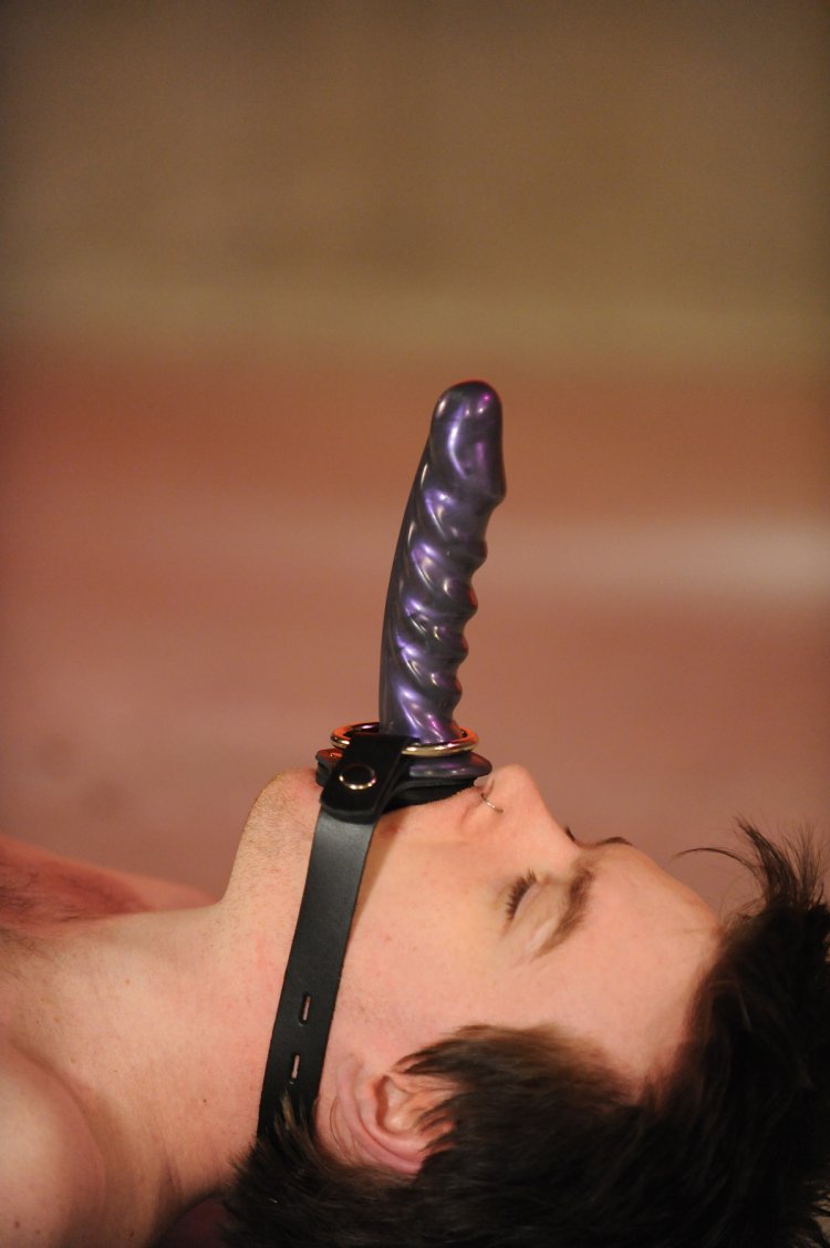 Strapon on the head of a slave