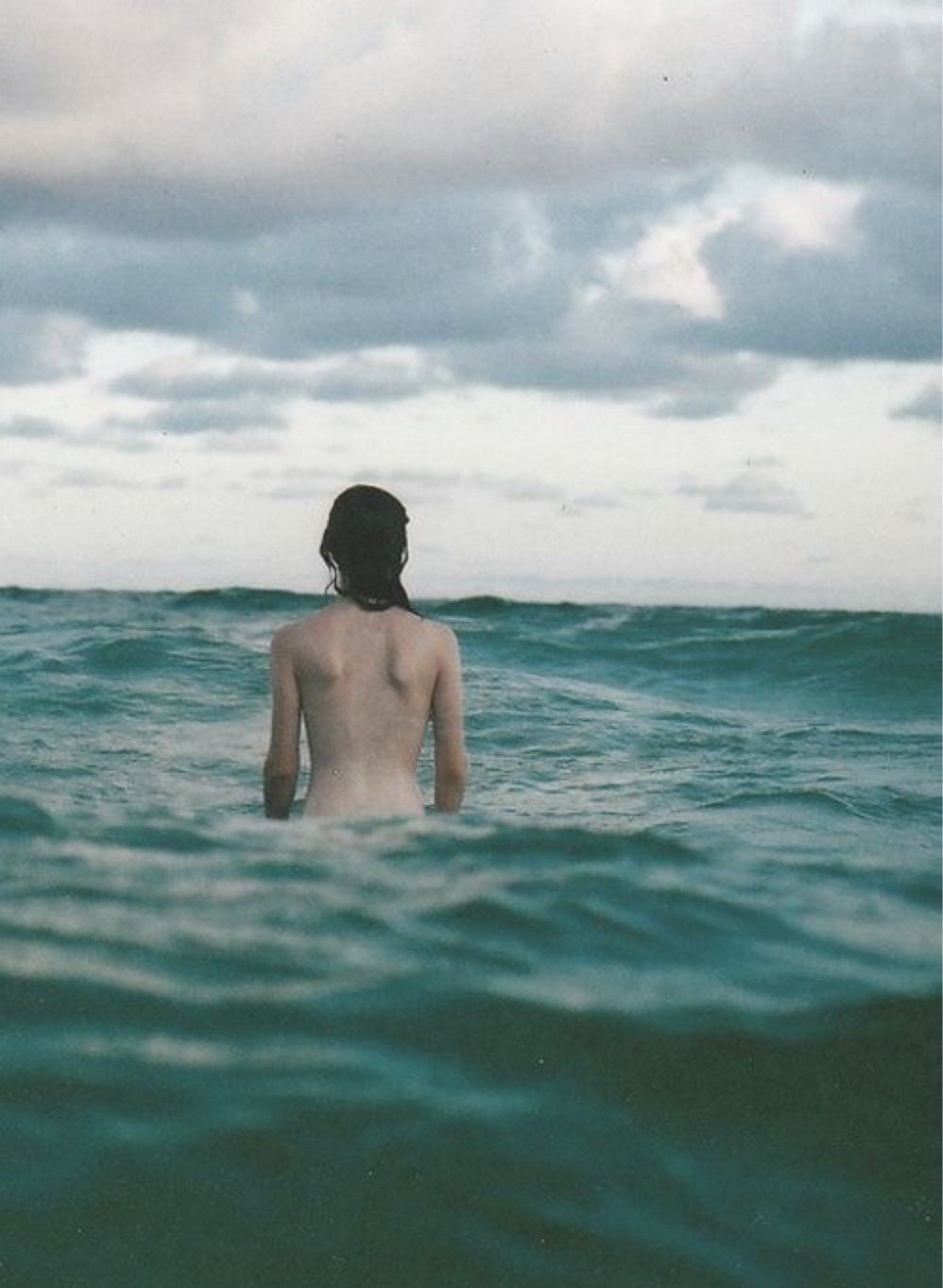 Girl enters the sea