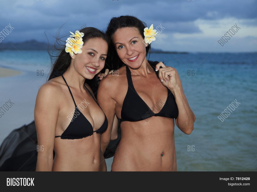 Daughter with mom bikini on the beach