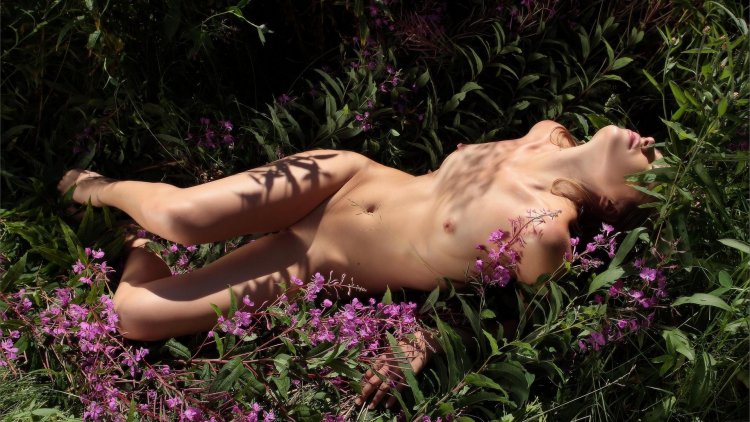 Naked in nature with flowers covered