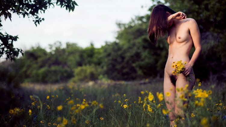Nude girl in the grass from above