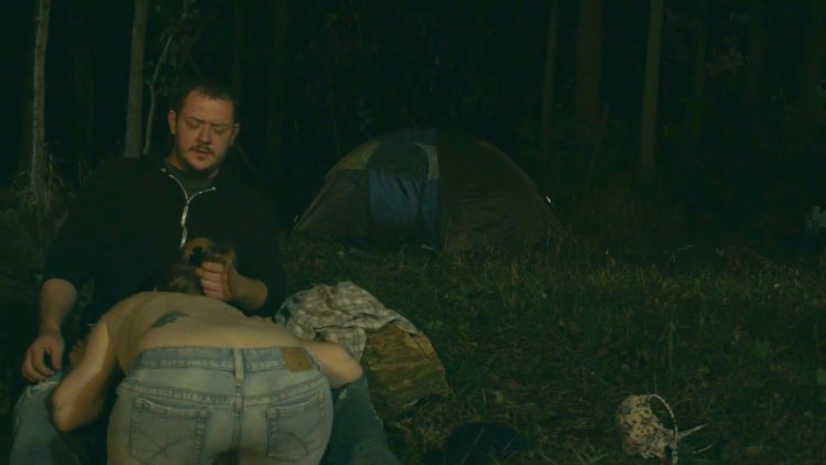 Naked men in a rustic bath