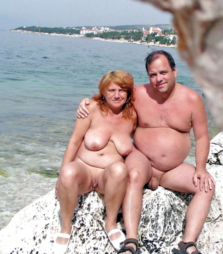 Naked mature couples on the beach