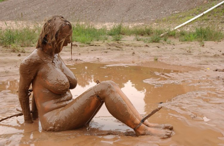 Naked women bathe in mud