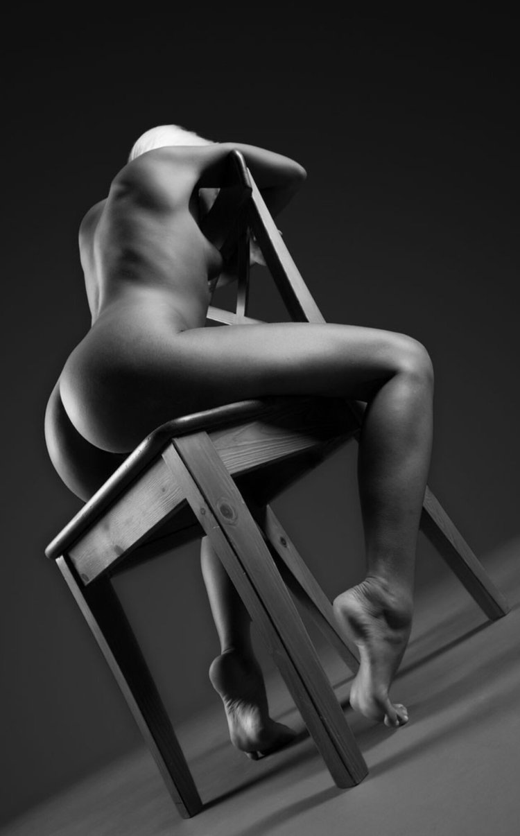 Erotic photo session on a chair