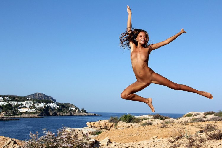 Naked gymnast in jump