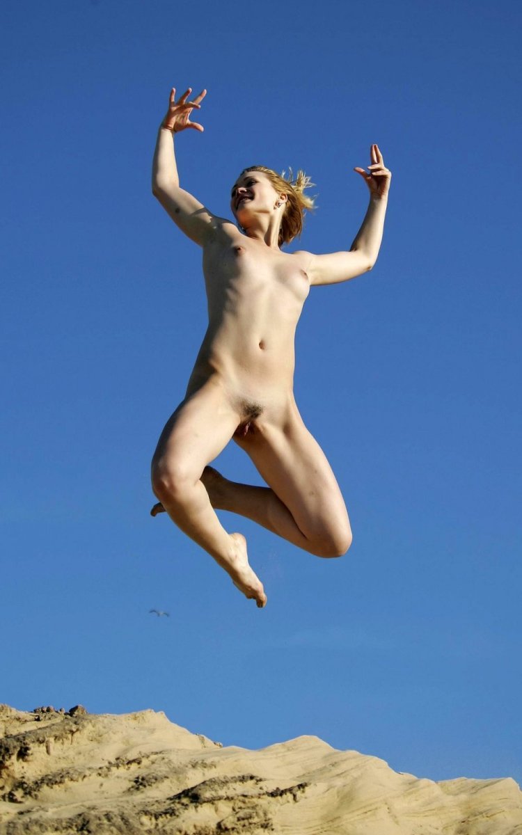 Naked brunettes in swimsuits on an empty beach