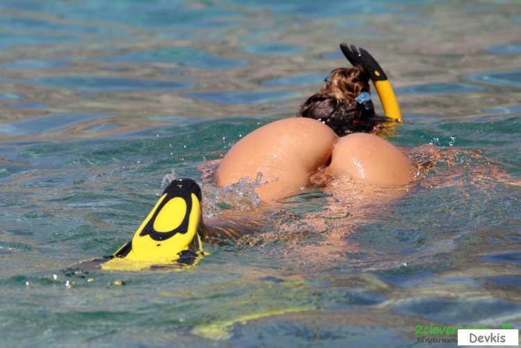 Naked women with flippers underwater