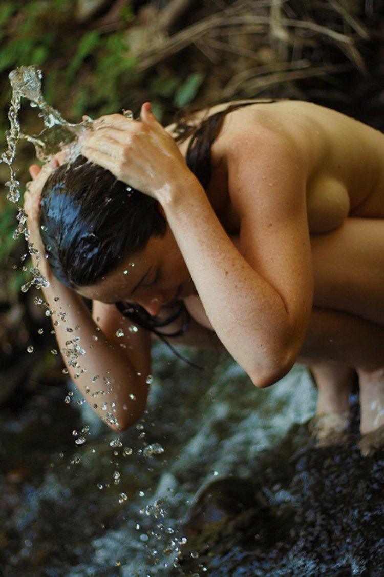 Naked splashes with water in nature