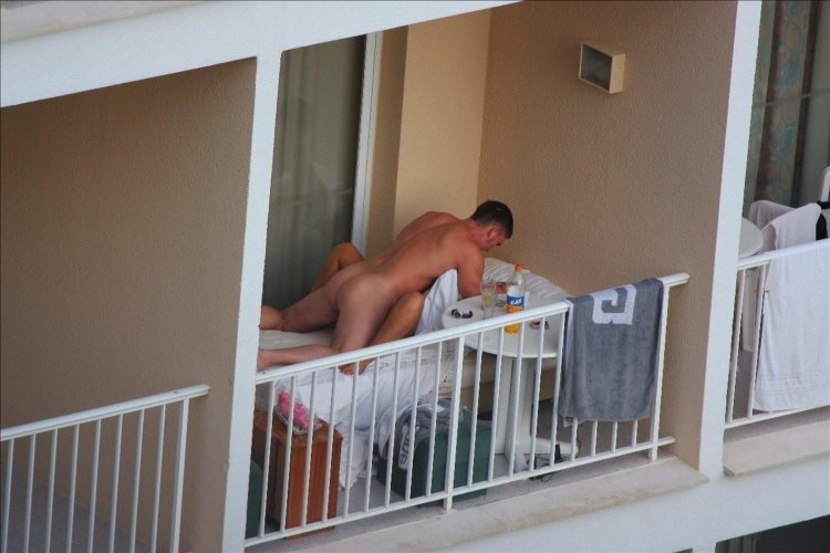 Naked on the balcony at the hotel