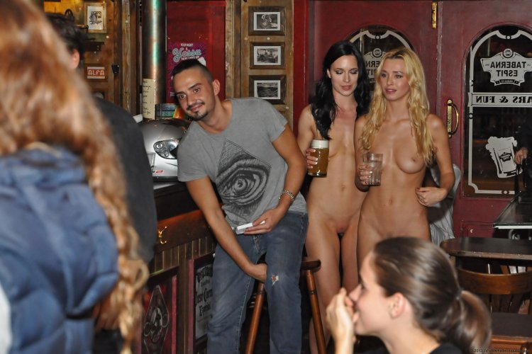 The girl undresses in a public place