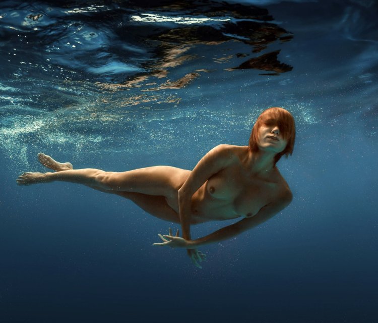 Naked girls swim underwater