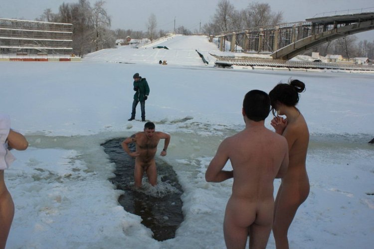 Naked guys bathed in an ice hole