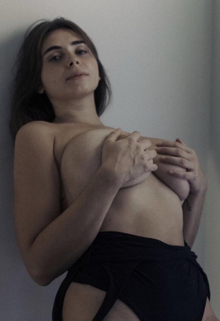 Isabella de Santos lies naked on his stomach