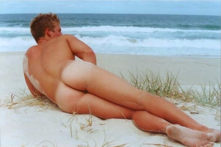 Naked men sunbathe on the beach