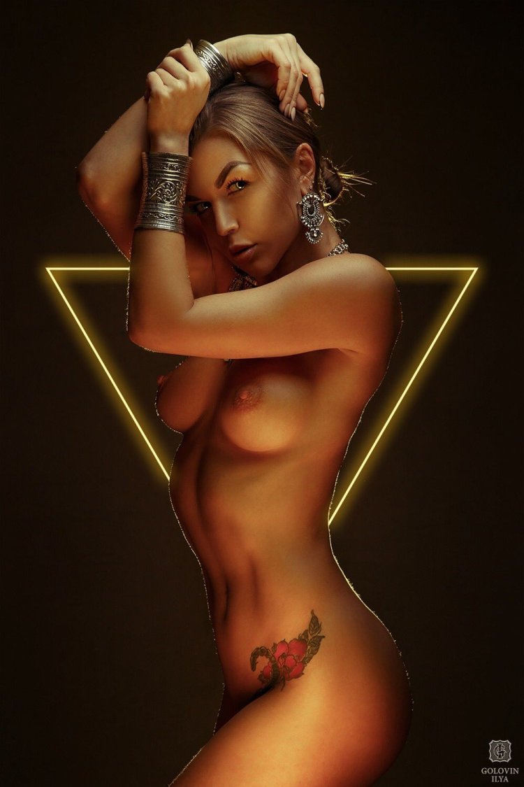 Girls with a short haircut lying in the dark nude art