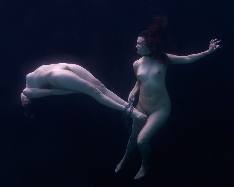 Naked women and guy in water