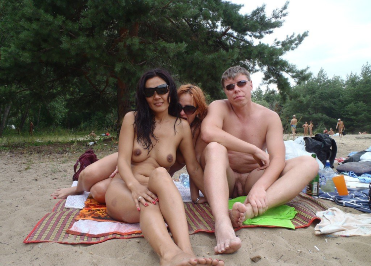Naked nudists sunbathe