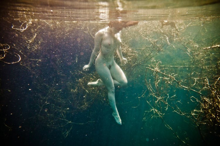 Naked with scuba dummy underwater