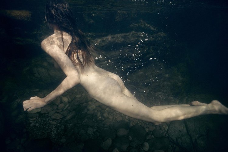 Naked girl in water at sea