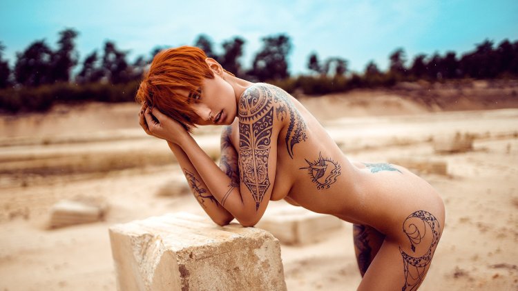 Naked female body in tattoos