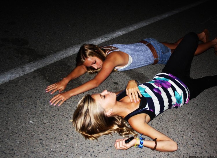Beautiful girls in the bathroom with a glass