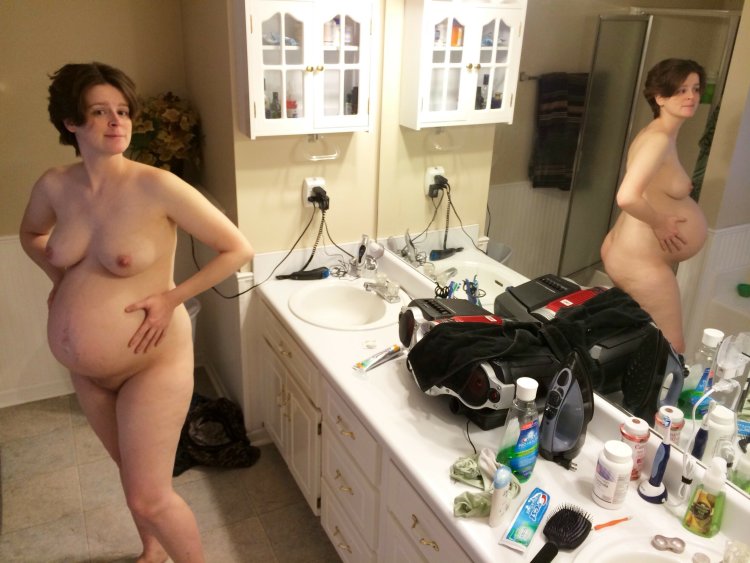 Naked pregnant women in the kitchen
