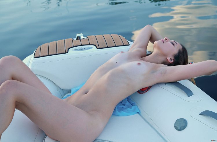 Nude in an inflatable boat like in a bath