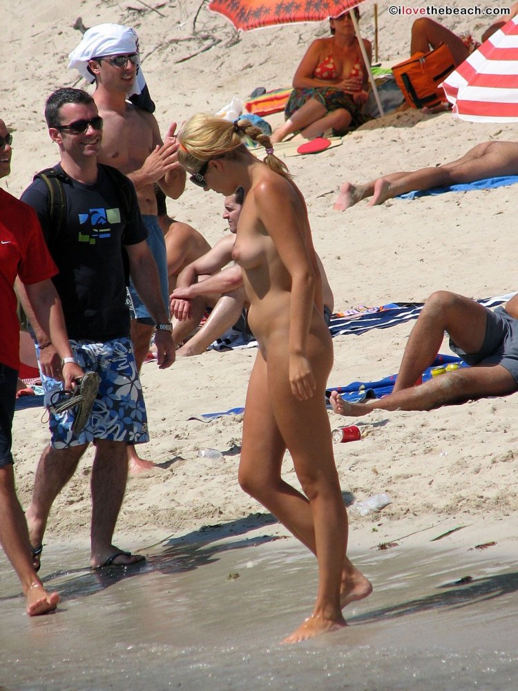 On a public beach without clothes