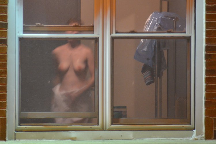 Naked women in the windows of houses