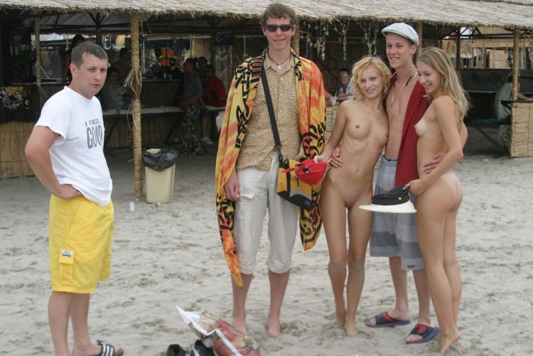 Undressed among those dressed on the beach