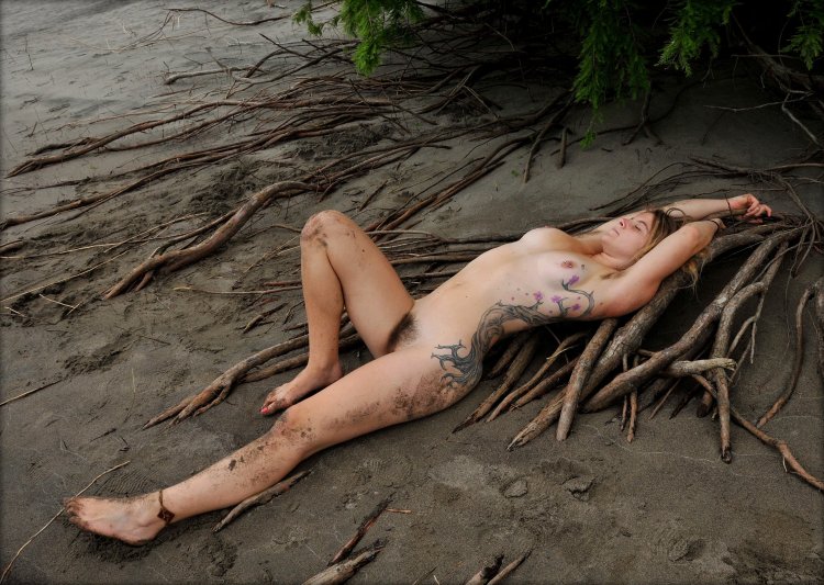 Naked women associated in mud