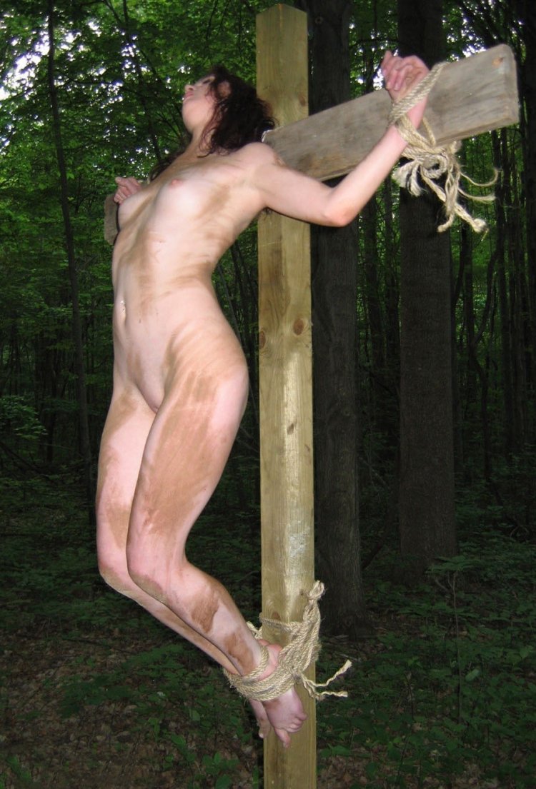 BDSM crucified at a height in the forest