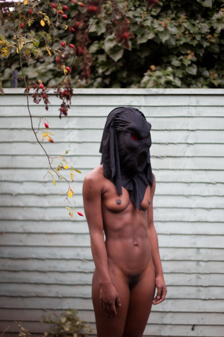 Naked black woman in a mask