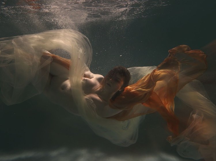 Naked man and woman in water